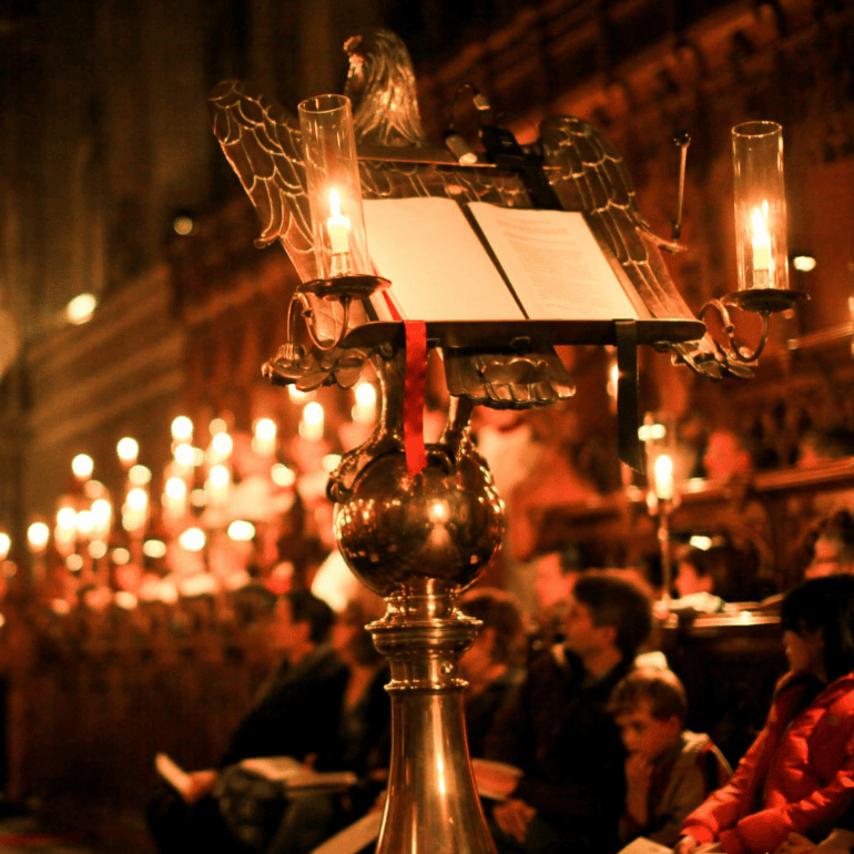 Candle lit photograph depicting Magdalen College Chapel. Central to the image is the eagle-shaped lectern.