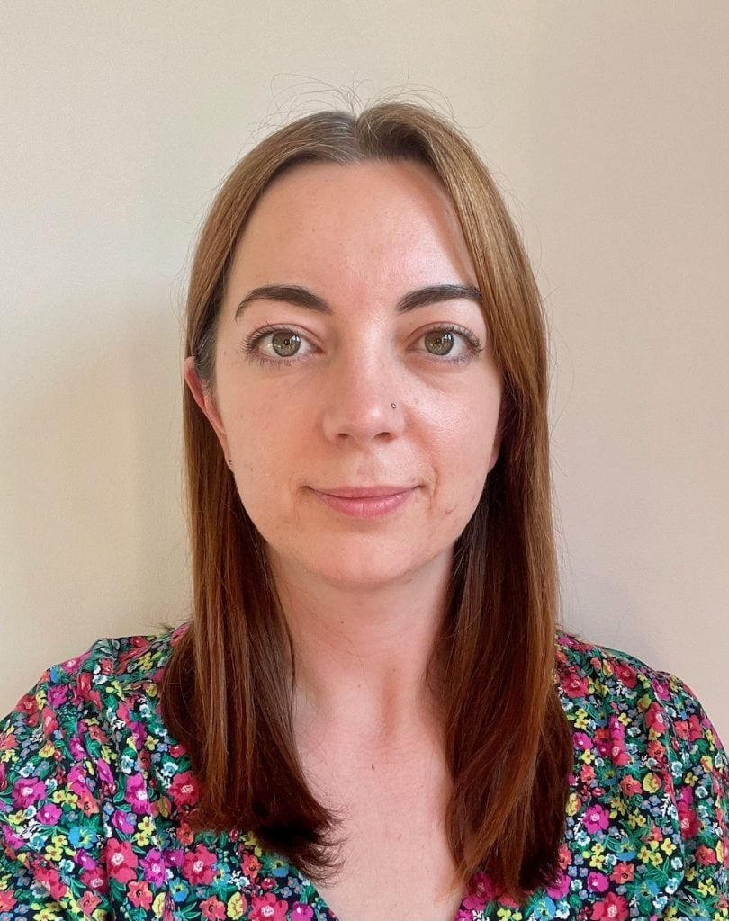 A woman with brown hair looking directly at the camera