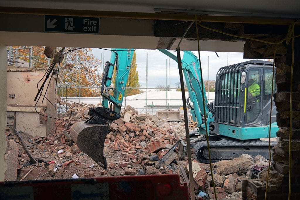 Digger on the fourth floor of the Waynflete during demolition