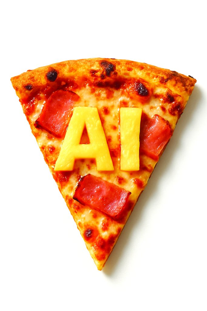 Slice of pizza with AI written in pineapple