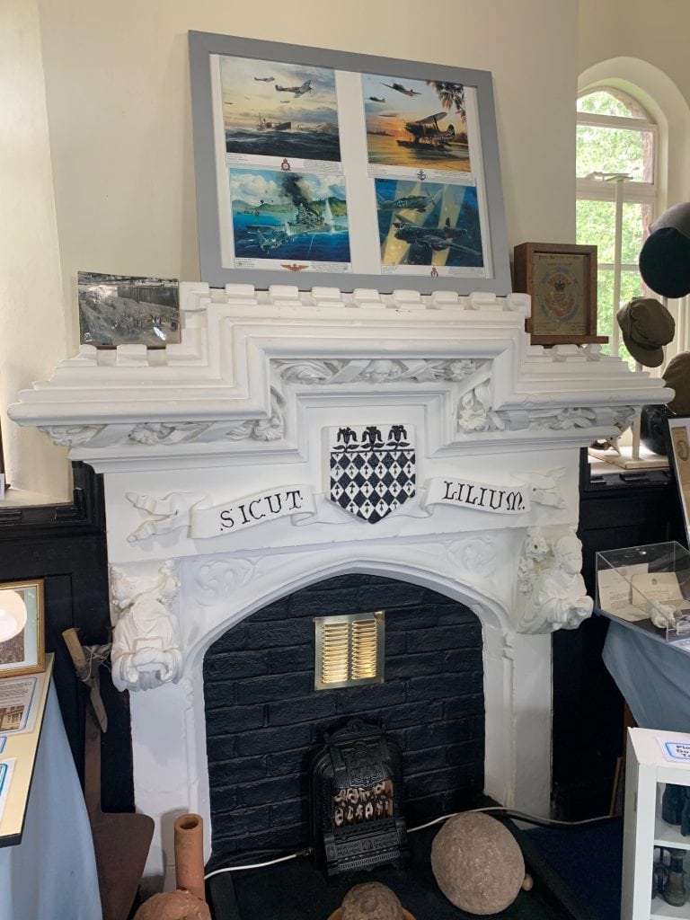 A fireplace showing the Magdalen Crest