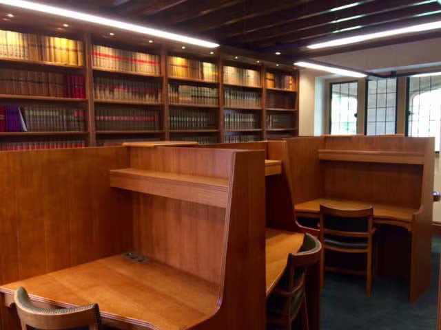 A room with study carrells and bookcases