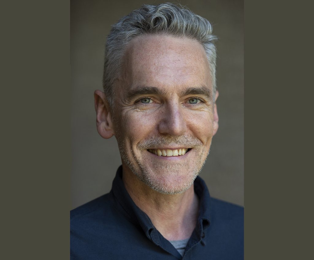 Picture of Ian McBride with bronwn background